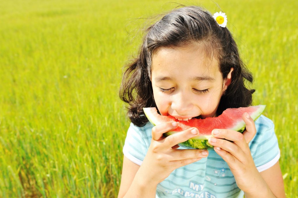 Girl eating watermelon because fruits are healthy!